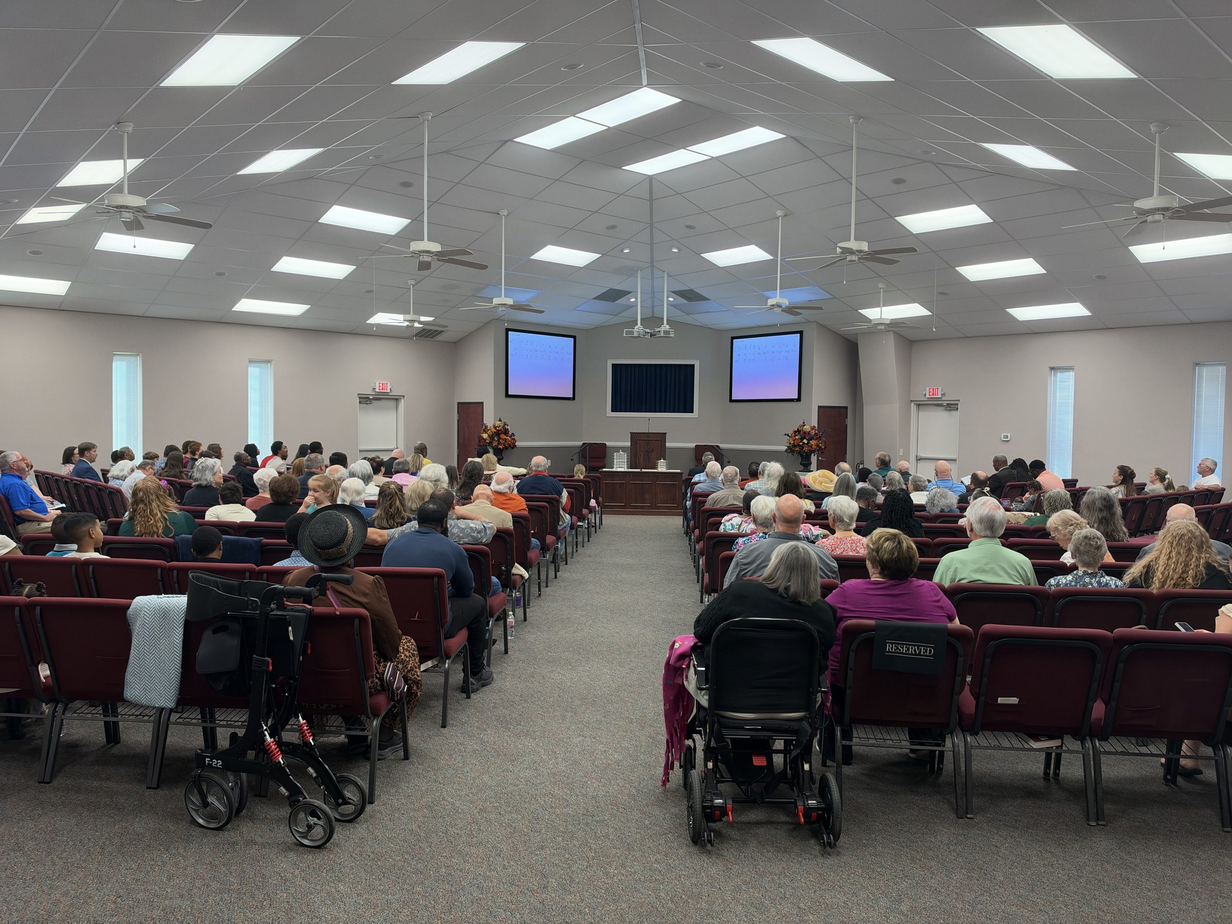 Members seated in the auditorium before Sunday worship